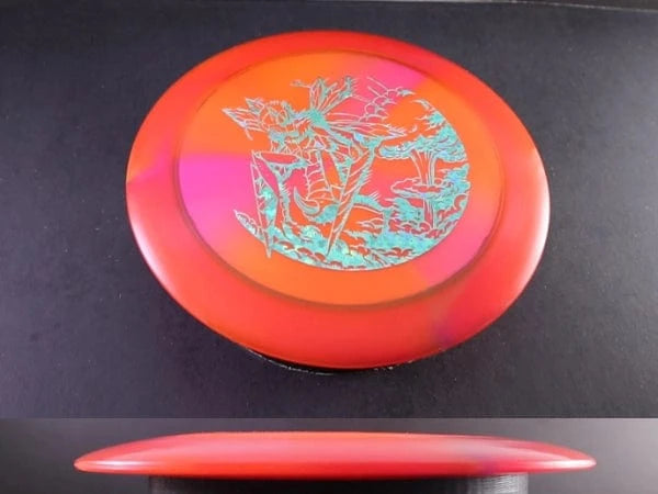 Red and orange disc golf disc with a design.
