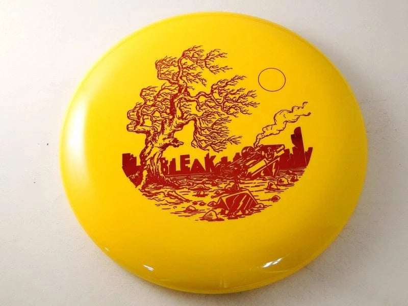 BleakHR yellow disc golf disc with apocalyptic tree scene