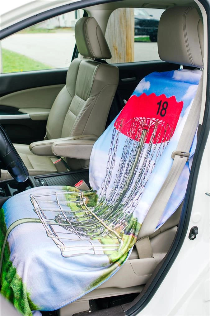 Towel seat cover with disc golf basket on car seat