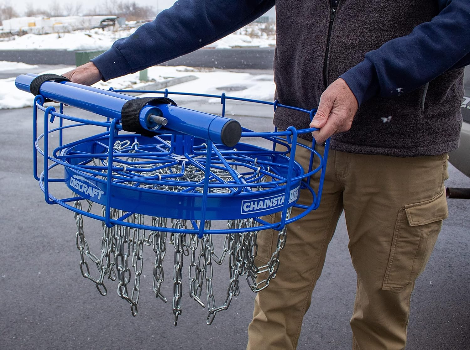 Blue disc golf pole holder being held