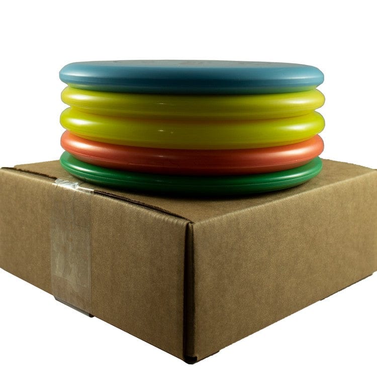 Stack of colorful frisbees on a cardboard box.