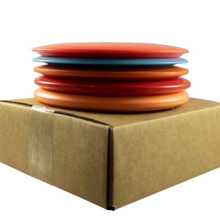 Stack of colorful disc golf discs on a box.